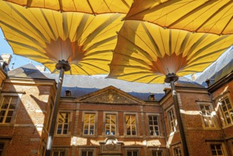 Court of honour covered by huge parasols at Commandery of Alden Biesen, 16th-century castle at
