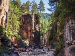 GEOPARC Bletterbach canyon, layers of sediments, stratum, people hike inside the gorge, Aldein,