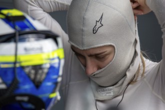 10 May 2024, Hockenheimring Germany : Spanish racing driver Alba Vazquez puts on her balavlava and