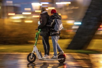 Young people riding in pairs on an e-scooter, Essen, North Rhine-Westphalia, Germany, Europe