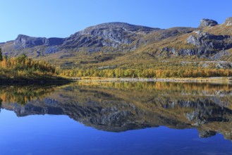 Mountains reflected in lake, autumn colours, sunny, bright, Stora Sjöfallet National Park, Laponia,
