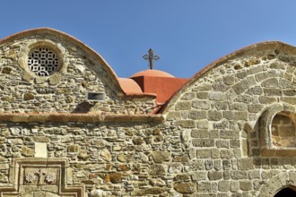 Historic church with detailed stone façade and red roof, Asklipio village, Asklipion, Kimisis tis