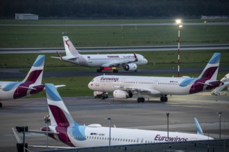 Düsseldorf Airport, Eurowings aircraft, in parking position, Tunisair on the taxiway for take-off