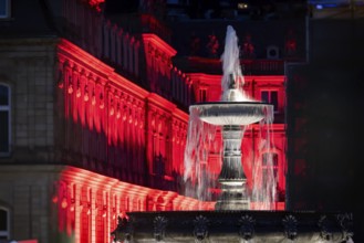 Court of honour on Schlossplatz. The New Palace and fountain are illuminated. Stuttgart,