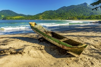 Primitive wooden fishing canoe on the sands of Castelhanos beach in Ilhabela, Castelhanos beach,