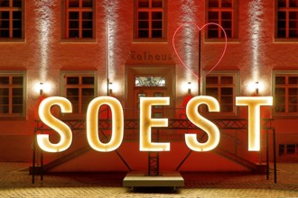 Illuminated town hall with Soest lettering in the evening at the Winterstrahlen Festival of Lights