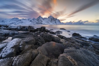 Coast near Vareid, fjord with snow-covered mountains, Flakstadøya, Lofoten, Norway, Europe