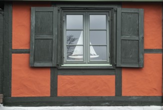 Window with sail boat in red half-timbered house in Ystad's historic city center, Skåne County,