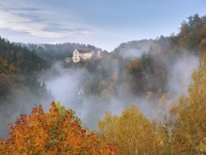 View of Rabenstein Castle in autumn, morning fog in Ahorntal, Waischenfeld, Upper Franconia,
