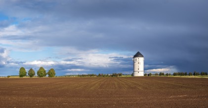 Water tower Crölpa-Löbschütz, field landscape with ploughed field under a stormy sky with dramatic