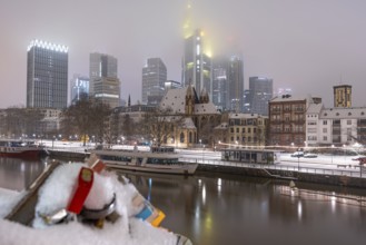 The skyscrapers of Frankfurt's banking skyline rise up from the snow-covered city centre into the