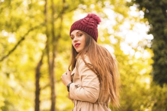Portrait of woman in autumn next to a forest in nature