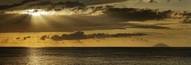 Sunset on the beach of Tropea with the Aeolian (Liparic) Islands and the volcanic island of