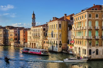 VENICE, ITALY, JUNE 27, 2018: Grand Canal with boats, vaporetto and gondolas on sunset from Rialto