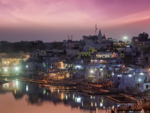 Sacred Puskhar lake (Sagar) and ghats of town Pushkar in twilight in the evening, Rajasthan, India,