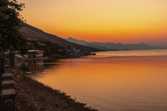 Beautiful orange summer sunset at Shkoder Lake in Shiroka Municipality. Albania