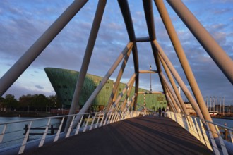 AMSTERDAM, NETHERLANDS, MAY 9, 2017: NEMO Science museum and Mr. J. van der Veldebrug bridge. It is