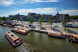 AMSTERDAM, NETHERLANDS, MAY 9, 2017: Aerial view of Amsterdam canal with tourist boats near