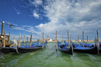 Gondolas and in lagoon of Venice by Saint Mark (San Marco) square with San Giorgio di Maggiore