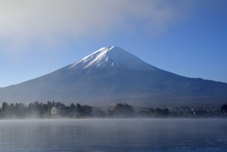 Volcano Fuji or Fudschijama with snow-capped summit, 3776 m high volcano, at Lake Kawaguchi,