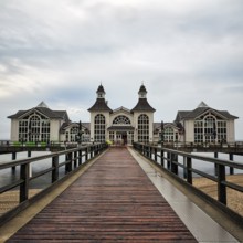 Sellin pier with individual tourists, rainy weather on the Baltic Sea, long exposure, Baltic Sea