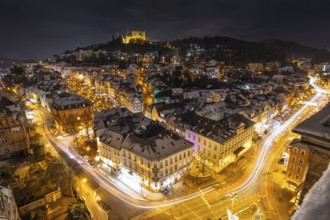 The lights of the snow-covered town of Marburg an der Lahn glow in the evening, Wetterau, Marburg,