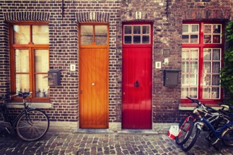 Doors of old houses and bicycles in european city. Bruges Brugge, Belgium, Europe