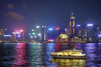 Hong Kong skyline cityscape downtown skyscrapers over Victoria Harbour in the evening illuminated