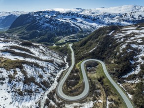 Aerial view of mountain road over the Haukelifjell, winding down to Roeldal, early spring, Norway,