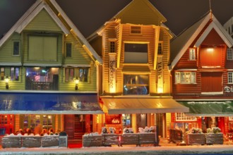 People sitting in front of a bar, winter, chrismas decoration, cold, gas powered heating stove