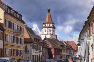 Historic tower Niggelturm and houses on the main street in rainy weather in Gengenbach, Black