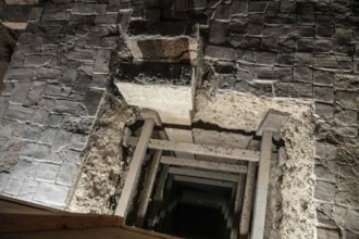 Wooden support structures inside a crumbling medieval stone passage at the royal palace of olite,