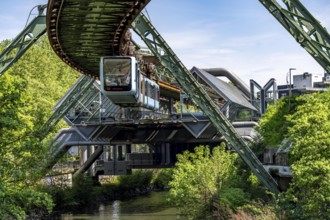 The Wuppertal suspension railway, train of the latest generation 15, floats above the Wupper,