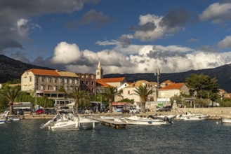 Town view with harbour and church Crkva Marija Pomocnica in Orebic, Peljesac peninsula, Croatia,
