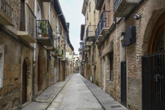 Empty narrow street with balconies and medieval buildings in the historic town of olite, navarre,