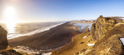 Panoramic view of Dyrholaey beach in cold winter with snow in Iceland, near Vik