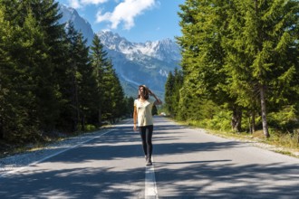 Young tourist walking on the road in Valbona valley, Theth national park, Albanian Alps, Valbona
