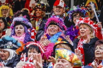 Colourfully costumed carnivalists celebrate carnival in Cologne, on Weiberfastnacht the street