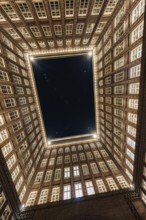 View upwards into an illuminated courtyard with many windows, Hamburg, Germany, Europe