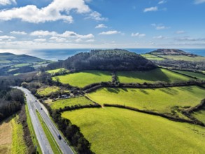 Farms over Road A35 from a drone, Morcombelake Village, Bridport, Dorset, England, United Kingdom,