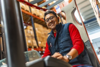 Close-up photo of a happy latin man worker driving forklift in a warehouse
