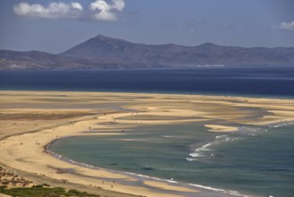 Endless beach Playa Risco del Paso, Playa de Sotavento with gentle waves, surrounded by mountains,