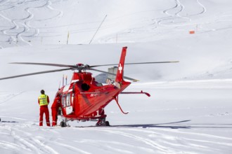 25 March 2024, Grindelwald, Switzerland: Rescue helicopter in action after a skiing accident