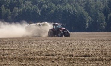 Upper Lusatia, Saxony, Germany - Dust-dry fields in a hot summer, a tractor working the field,
