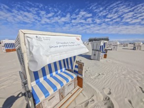 Preparing for the high season on the beach, setting up the beach chairs, North Sea, on the edge of