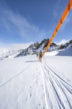 Ski tourer with rope, rope team on the Vadret da Porchabella glacier on the ascent to the summit of