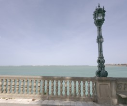 View over the bay of Cadiz with lamppost from the garden Jardines Clara Campoamor, Cádiz, Spain,