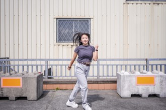 Modern young beauty woman dancing k-pop korean dance in the city