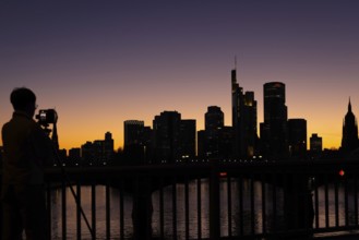 The silhouette of Frankfurt's banking skyline stands out in the evening against the residual light
