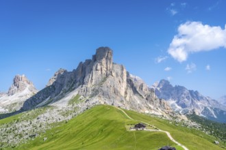 Stunning landscape featuring the rugged peaks and verdant slopes of passo giau in the italian